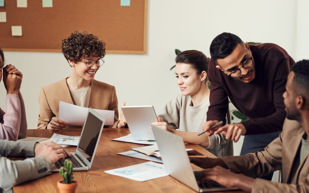 Managers reviewing printed reports and dashboards during a project meeting